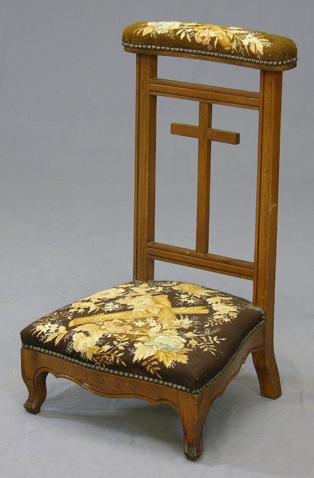 Carved Oak Prie Dieu, c. 1870, the cross carved ba: Carved Oak Prie Dieu, c. 1870, the cross carved back splat flanked by reeded supports, to cabriole legs joined by shaped skirts, the arm rest and seat with needlepoint upholstery, H.- 33 in.