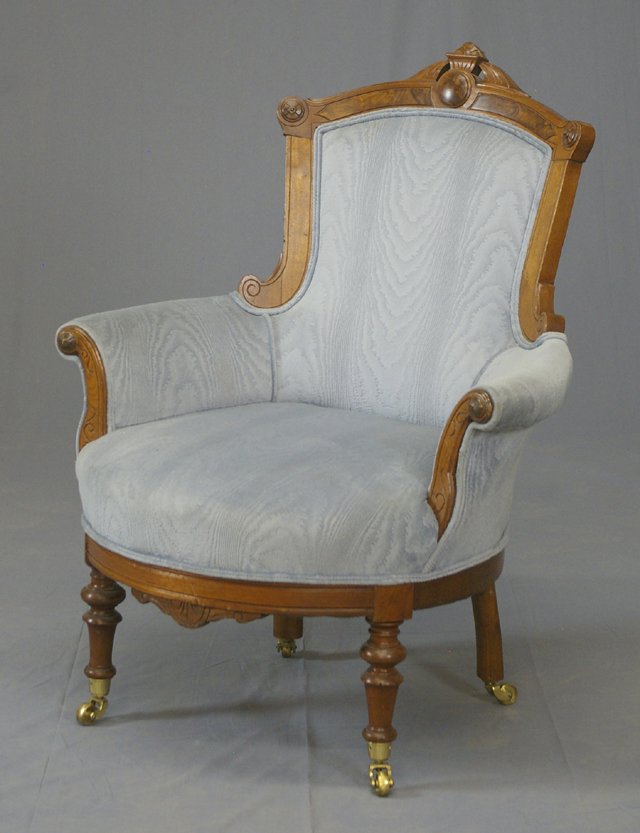 American Carved Walnut Eastlake Upholstered Berge: American Carved Walnut Eastlake Upholstered Bergere, c. 1890 with a leaf carved crest above the upholstered back with scrolled arms, on turned legs to brass cup casters, H.- 40 in.
