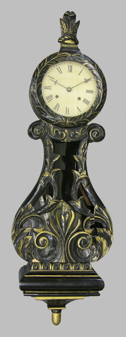 Carved and Ebonized Wood Louis XV Style Wall Cloc: Carved and Ebonized Wood Louis XV Style Wall Clock, 20th c., time and strike, with a leaf carved finial over a leaf carved bezel, above a pierced carved pendulum door, to a stepped base with a turned 