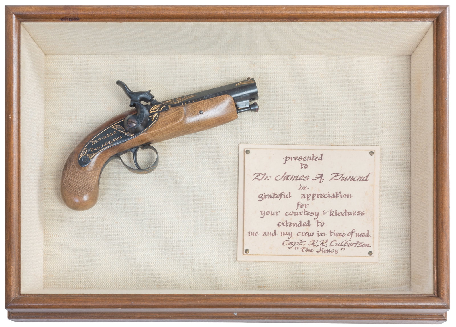 Antique Style Derringer, 20th c., Case- H.- 3 in., W.- 16 in., D.- 11 1/4 in.: Antique Style Derringer, 20th c., serial # 17399, with gilt decoration, percussion cap black powder pistol, .44 caliber, marked in gold paint "Derringer Philadelphia," in a glazed wood display case, C
