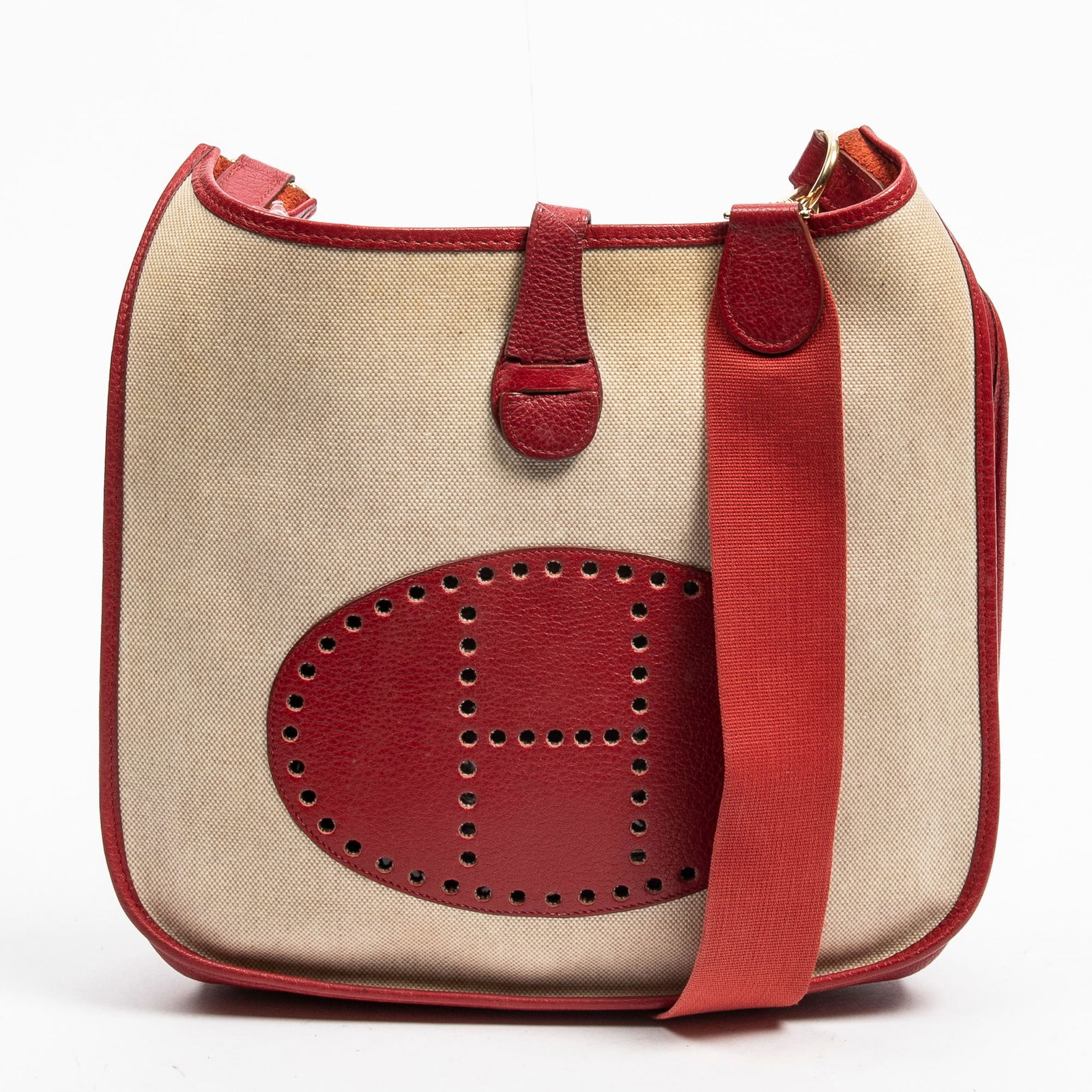 Vintage Hermes Evelyne I Bicolor Crossbody Bag, 1998, H.- 12 in., W.- 13 in.: Vintage Hermes Evelyne I Bicolor Crossbody Bag, 1998, in red Clemence leather and beige toile, with gold plated hardware and canvas strap, perforated front with snap closure, opening to an unlined int