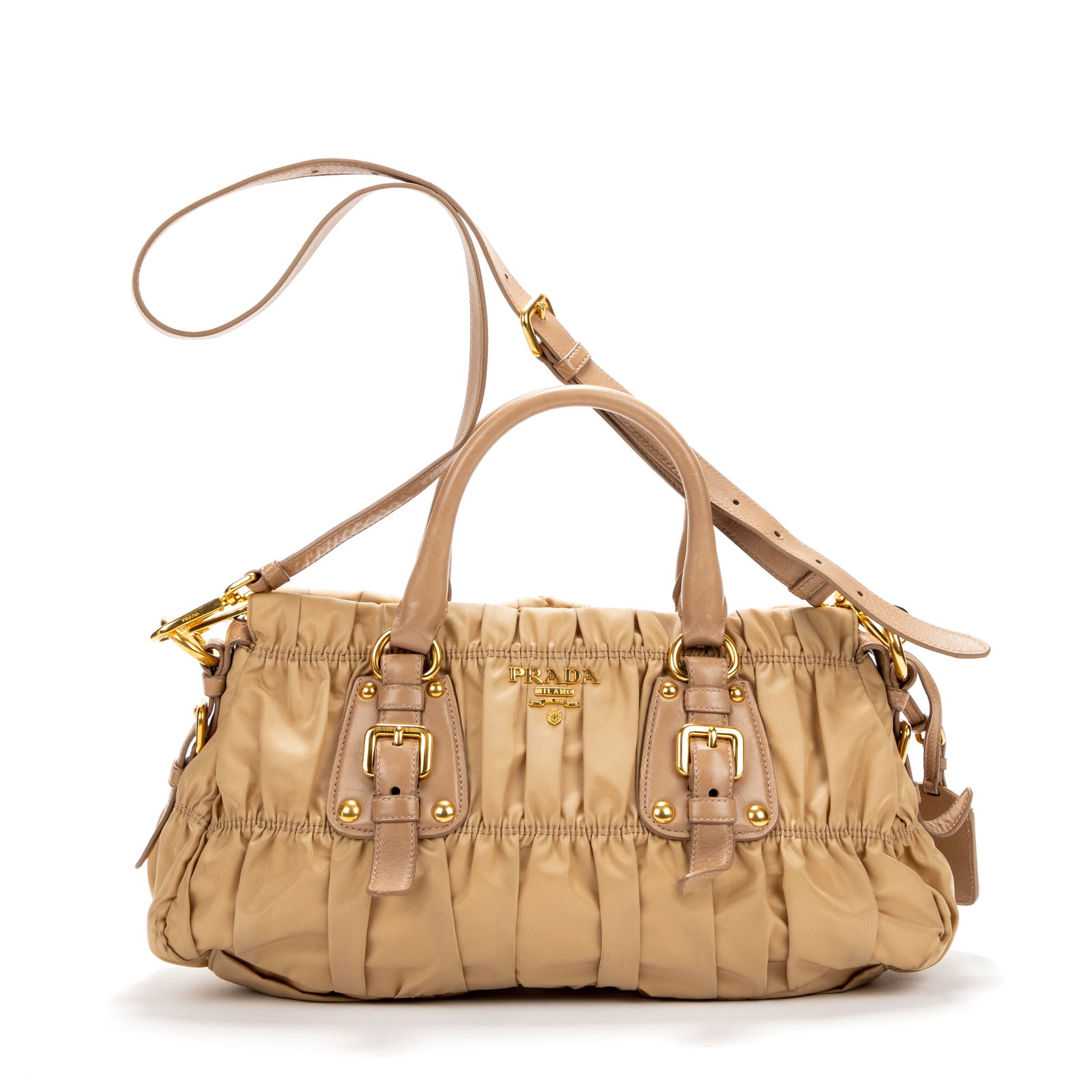 Prada Top Handle Handbag, H.- 8 1/2 in., W.- 15 1/2 in.: Prada Top Handle Handbag, in beige pleated nylon, with brown leather and golden brass hardware, top handles with buckles, adjustable shoulder strap, top zip closure, opening to a monogram canvas linin