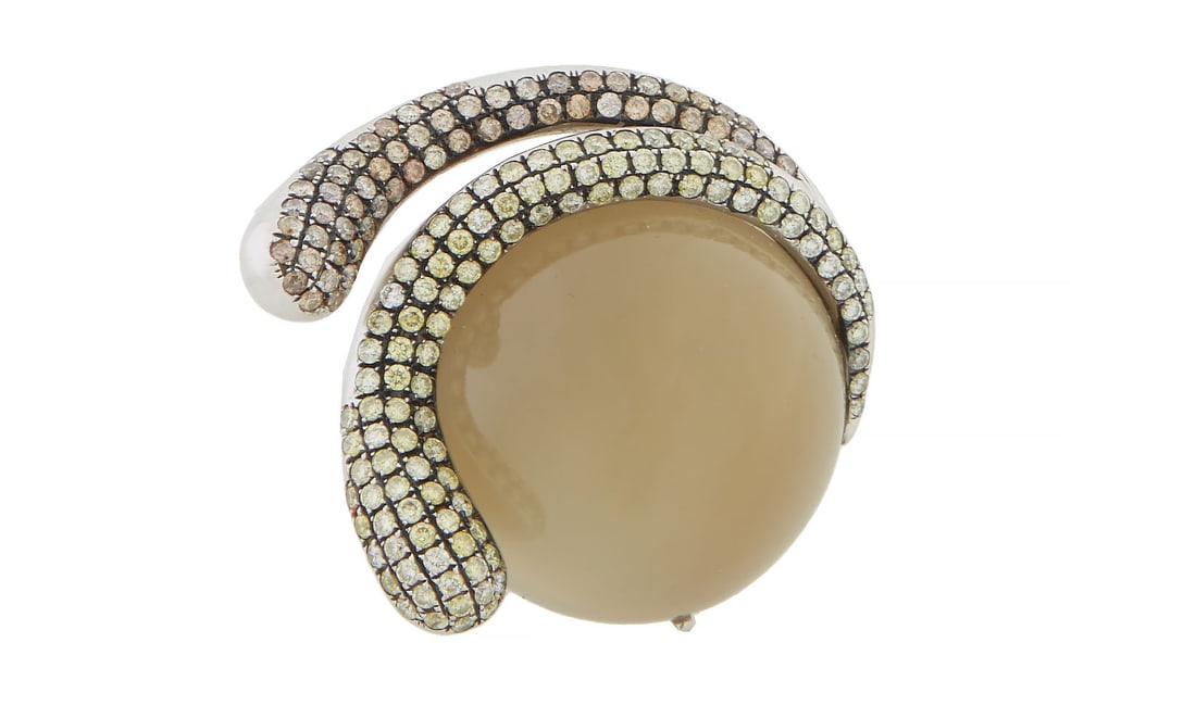 18K White Gold Star Orthoclase and Diamond Ring, Total Diamond Wt.- approx. 1.49 carats, Size- 5: 18K White Gold Star Orthoclase and Diamond Ring, the ring mounted with a double cabochon 66.22 carat four ray star orthoclase feldspar, accented by tiny round yellow and brown diamonds, Total Diamond 
