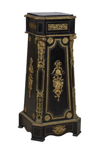 French Gilt Ormolu Mounted Ebonized Pedestal, early 20th c., H.- 46 1/4 in., W.- 20 in., D.- 20 in.: French Gilt Ormolu Mounted Ebonized Pedestal, early 20th c., the inset square top over inset pierced bronze scrolled panels, over tapered sides with applied ormolu musical instruments, flanked by cant