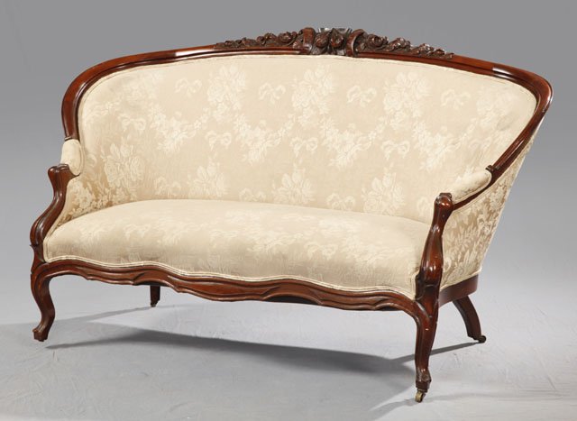 American Late Victorian Carved Mahogany Settee, c. : American Late Victorian Carved Mahogany Settee, c. 1900, with a floral and nut carved crest, over a rounded corner back, to a serpentine seat, the whole on cabriole legs to toupie feet, H.- 37 1/2 in.