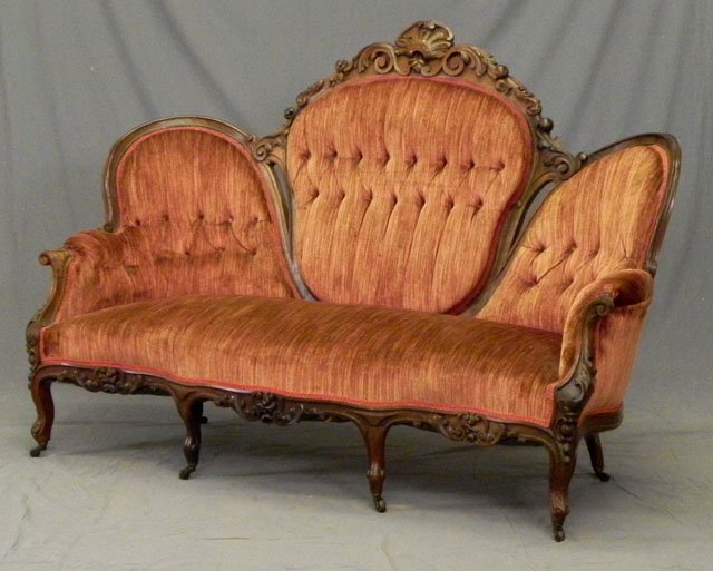 American Victorian Carved Walnut Chair Back Settee: American Victorian Carved Walnut Chair Back Settee, late 19th c., the floral and acanthus carved crest over a central button back section, flanked by two button Back side sections, to leaf carved scro