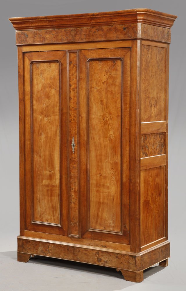 Louis Philippe Carved Elm Armoire, c. 1850, the he: Louis Philippe Carved Elm Armoire, c. 1850, the hexagonal canted corner crown over paneled double doors within canted sides, the whole on a plinth base with bracket feet, H.- 87 1/4 in., W.- 54 1/2 in