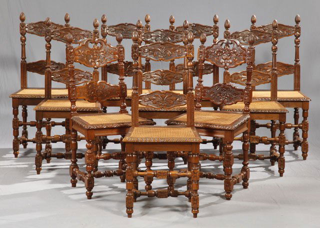 Set of Nine Henri II Carved Mahogany Side Chairs,: Set of Nine Henri II Carved Mahogany Side Chairs, 19th c., the floral and leaf carved back rails flanked by pineapple finials, over afloral and leaf carved horizontal back splat, to caned seats, on tu