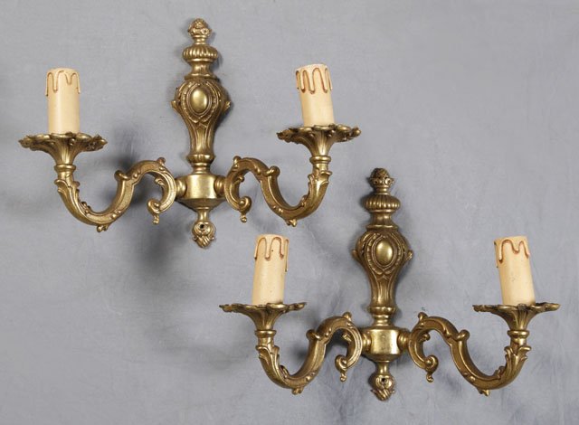 Two Pair of Brass Louis XV Style Wall Sconces, ear: Two Pair of Brass Louis XV Style Wall Sconces, early 20th c., one a pair of two light examples with relief decoration and urn form back plates, the other a pair of single light sconces with floriform 