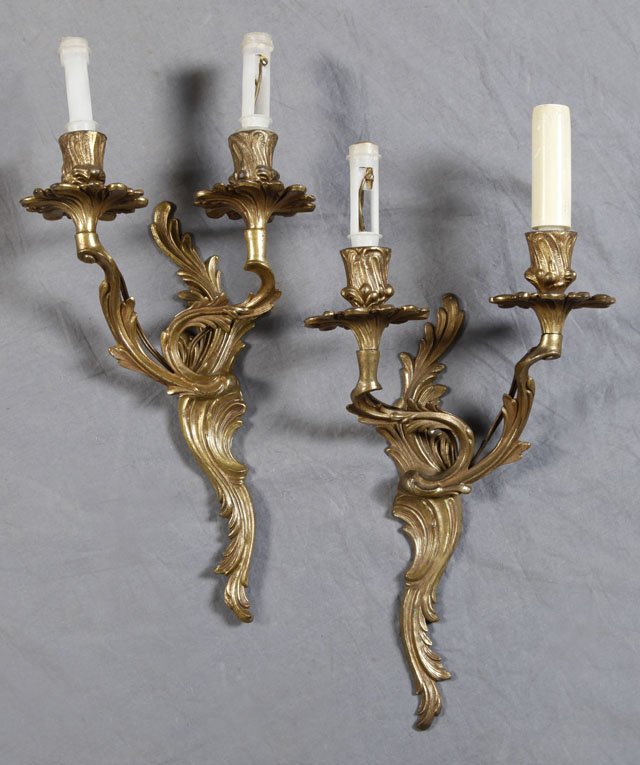 Two Pair of Louis XV Style Brass Wall Sconces, ear: Two Pair of Louis XV Style Brass Wall Sconces, early 20th c., a pair of two light examples on swirled arms to swirled back plates, and a pair of single arm sconces with floriform bobeches, and swirled