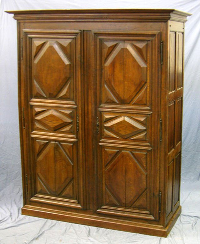 Louis XIII Carved Walnut French Provincial Armoir: Louis XIII Carved Walnut French Provincial Armoire, c. 1800, the stepped crown over double doors and sides with relief diamonds, the doors with steel fiche hinges and escutcheons, on a plinth base , H