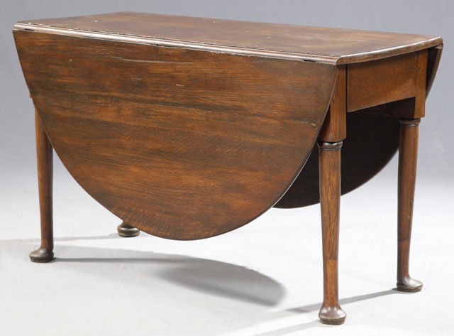 English Carved Oak Oval Queen Anne Style Drop Lea: English Carved Oak Oval Queen Anne Style Drop Leaf Gateleg Dining Table, c. 1920, on tapered cylindrical legs to pad feet, H.- 28 3/4 in., W.- Closed- 20 in., Open- 62 in., D.- 46 1/2 in.