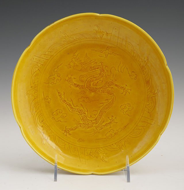Chinese Yellow Glazed Earthenware Plate, late 19t: Chinese Yellow Glazed Earthenware Plate, late 19th c., with a scalloped rim, the interior with incised dragon and cloud decoration, H.- 1 3/8 in., Dia.- 8 1/2 in.