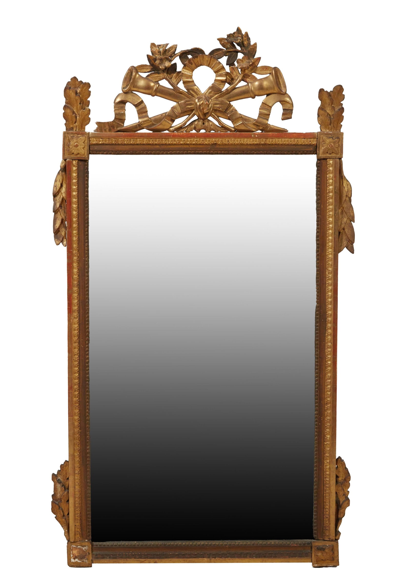 French Empire Carved Giltwood and Gesso Mirror, 19th c., H.- 54 in., W.- 30 in.: French Empire Carved Giltwood and Gesso Mirror, 19th c., the foliate and floral bowknot trophy crest with leaf finials and side sprays, with a lamb's tongue outer surround and a beaded inner liner, en