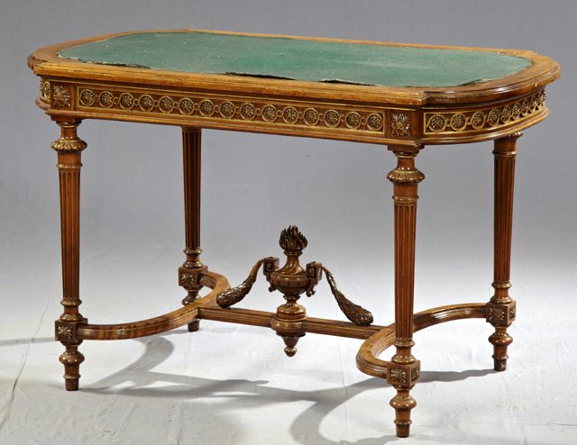 Louis XVI Style Carved Walnut Tortoise Top Writing: Louis XVI Style Carved Walnut Tortoise Top Writing Table, 19th c., the skirt with gilt relief carved rosettes all around, the whole on reeded tapered legs with a curved H-form stretcher, the top inset