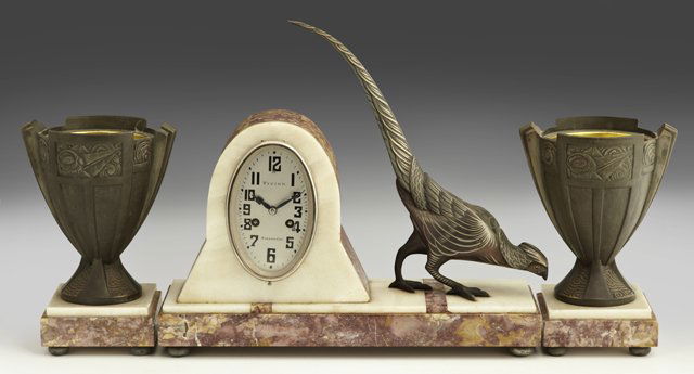 Three Piece French Art Deco Patinated Spelter, Ony: Three Piece French Art Deco Patinated Spelter, Onyx and Marble Clock Set., c. 1930, with an oval drum clock by Vivier, time and strike, on an inlaid marble and onyx base with a large patinated spelter