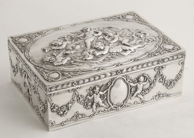 Exquisite Sterling Repousse Dresser Box, early 20t: Exquisite Sterling Repousse Dresser Box, early 20th c., Germany, the lid depicting winged putto riding on dolphin fish, each side with repousse decoration of putti with arrows and floral garlands, the