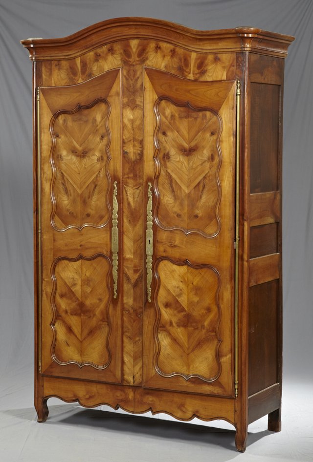 Louis XV Style Carved Cherry Armoire, c. 1830, the: Louis XV Style Carved Cherry Armoire, c. 1830, the arched ogee crown over highly figured shaped double panel doors with long brass escutcheons and fiche hinges, the whole on cabriole legs, H.- 93 1/4 