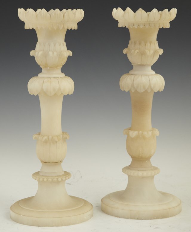 Pair of Carved Alabaster Candlesticks, early 20th: Pair of Carved Alabaster Candlesticks, early 20th c., with relief decorated candle cups on relief leaf decorated supports, to a circular stepped bases, H.- 11 1/2 in., Dia.- 4 3/4 in.