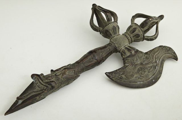 Chinese or Tibetan Bronze Ceremonial Axe, 20th c.,: Chinese or Tibetan Bronze Ceremonial Axe, 20th c., the handle with relief dragon decoration, H.- 17 in., W.- 9 in., D.- 2 1/2 in.