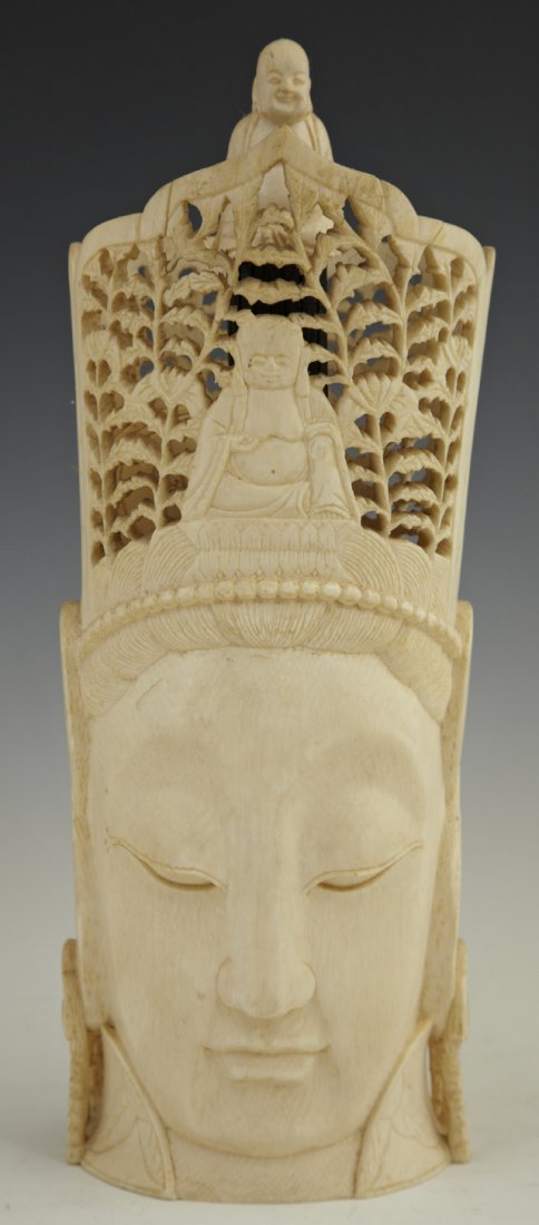 Japanese Meiji Carved Tusk Ivory Head of the Crow: Japanese Meiji Carved Tusk Ivory Head of the Crowned Buddha, early 20th c. the head surmounted by an ivory figure of Ho-tei, signed on the base in calligraphy, the crown with elaborate leaf reticulati