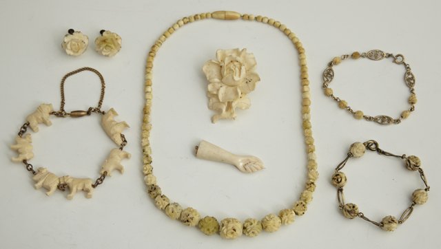 Group of Seven Pieces of Carved Ivory Jewelry, 20: Group of Seven Pieces of Carved Ivory Jewelry, 20th c., consisting of three link bracelets, a hand pendant, a floral brooch, a pair of earrings, and a necklace. (7 Pcs.)