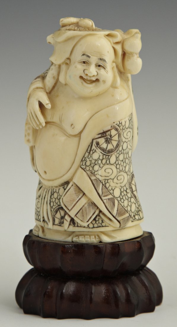 Unusual Carved Ivory Figural Box, early 20th c., : Unusual Carved Ivory Figural Box, early 20th c., in the form of a standing Hotei, with relief and scrimshaw decoration, the lid with fruit carving, on a carved wooden base, H.- 4 1/4 in., W.- 2 1/4 in