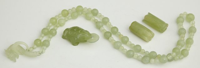 Four Pieces of Oriental Carved Green Jade, early : Four Pieces of Oriental Carved Green Jade, early 20th c., consisting of a bead necklace with a dragon clasp, a frog pendant, and two cicada carved beads, Necklace- H.- 32 in.