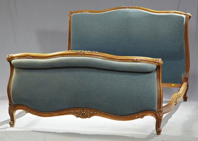 Louis XV Style Carved Cherry Bed, early 20th c.,: Louis XV Style Carved Cherry Bed, early 20th c., the serpentine upholstered headboard rim with central carved flowers, to a like footboard, on floral carved cabriole legs to scrolled toes, the arched