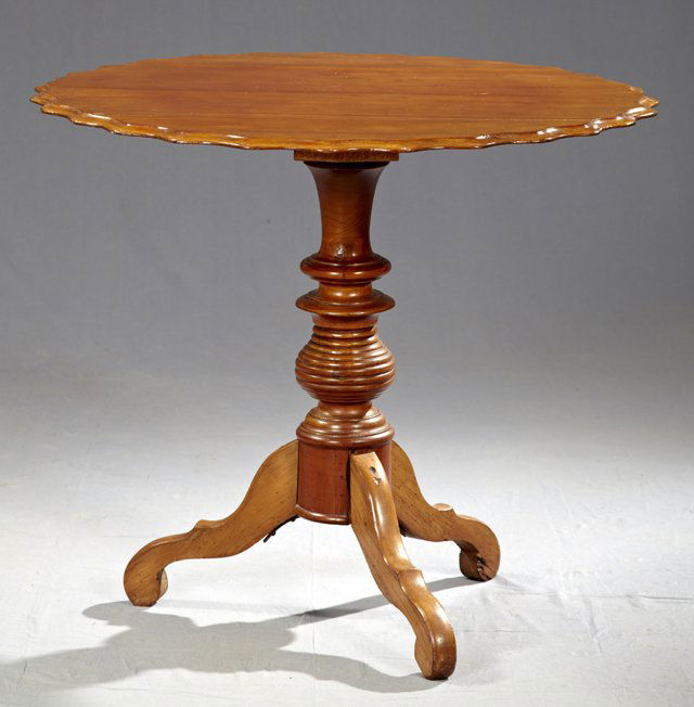 Continental Carved Mahogany Circular Tea Table, l: Continental Carved Mahogany Circular Tea Table, late 19th c., the scalloped ogee edge top on a well turned tapered support to tripodal cabriole legs, H.- 27 1/2 in., W.- 32 1/2 in.