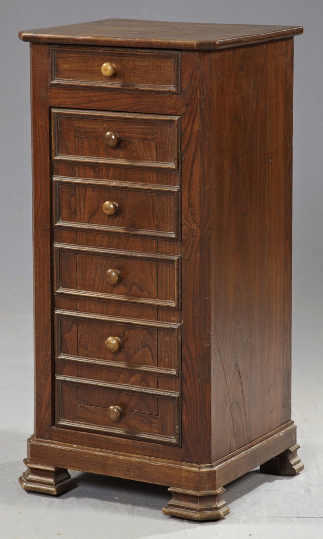 Carved Elm Night Stand, 19th c., the canted corne: Carved Elm Night Stand, 19th c., the canted corner hexagonal top over a frieze drawer and a cupboard door with five faux drawers, on a plinth base to stepped block feet, H.- 33 3/4 in., W.- 16 1/2 in.