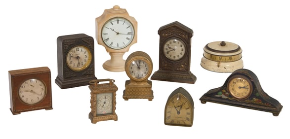 Group of Nine Small Mantel Clocks, early 20th c., Largest Ironclad- H.- 2 1/2 in., Dia.- 5 in. (9