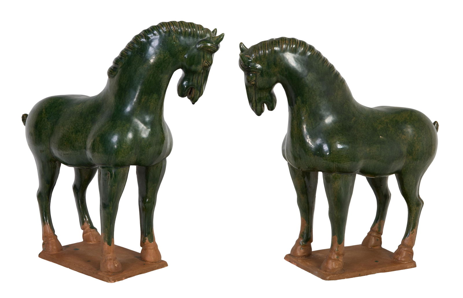 Pair of Chinese Tang Dynasty Style Pottery Horses, 20th c., Each- H.- 17 1/2 in., W.- 6 in., D.- 19: Pair of Chinese Tang Dynasty Style Pottery Horses, 20th c., in opposing stances, with green glaze over terra cotta bodies on a rectangular base, Each- H.- 17 1/2 in., W.- 6 in., D.- 19 in. (2 Pcs.)