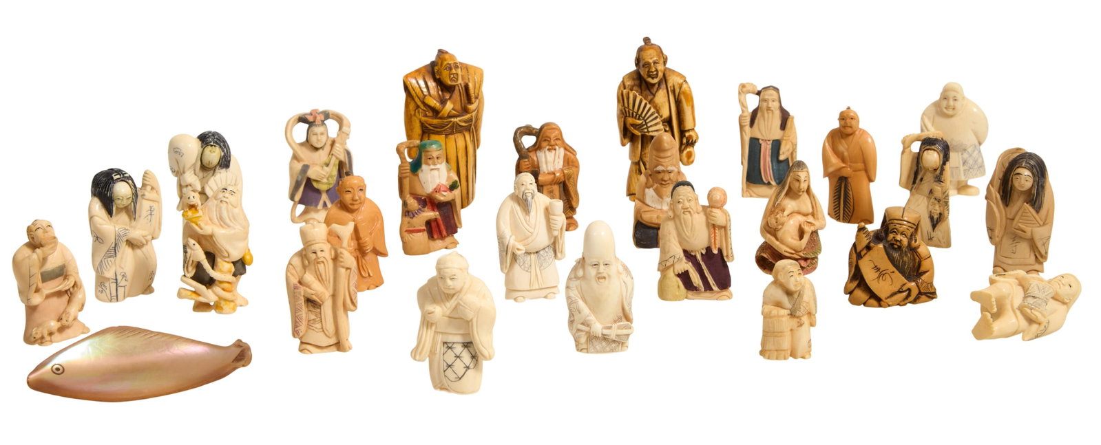 Group of Twenty-Six Figural Netsukes, 19th/20th c., Fish- H.- 5/8 in., W.- 3 3/8 in., D.- 1 3/8 in.: Group of Twenty-Six Figural Netsukes, 19th/20th c., including 19 in the form of sages, 1 mother feeding her child, 1 musician, 4 with rotating faces, and 1 fish example made of shell, Fish- H.- 5/8 in