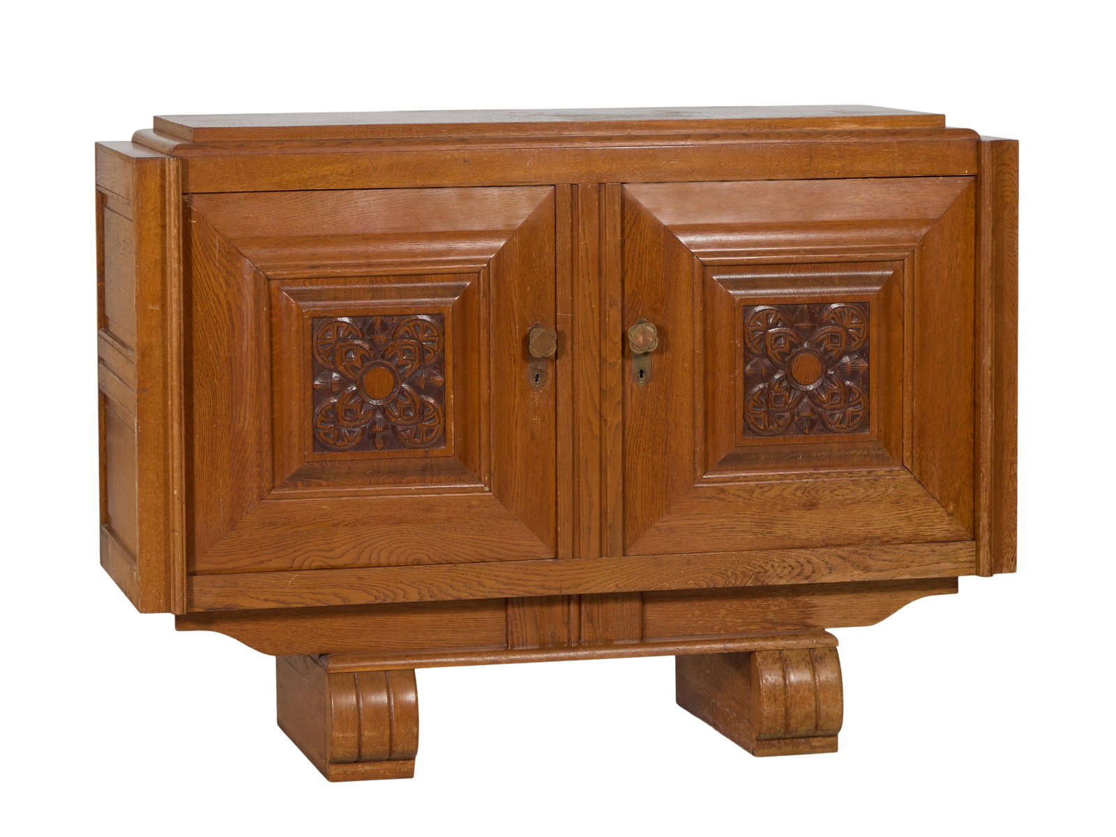 French Art Deco Oak Sideboard, early 20th c., H.- 40 in., W.- 55 1/2 in., D.- 20 in.: French Art Deco Oak Sideboard, early 20th c., the restrained stepped top over two doors with geometric carved central panels, with stepped moulded surround, on incised shaped rounded runner feet, matc