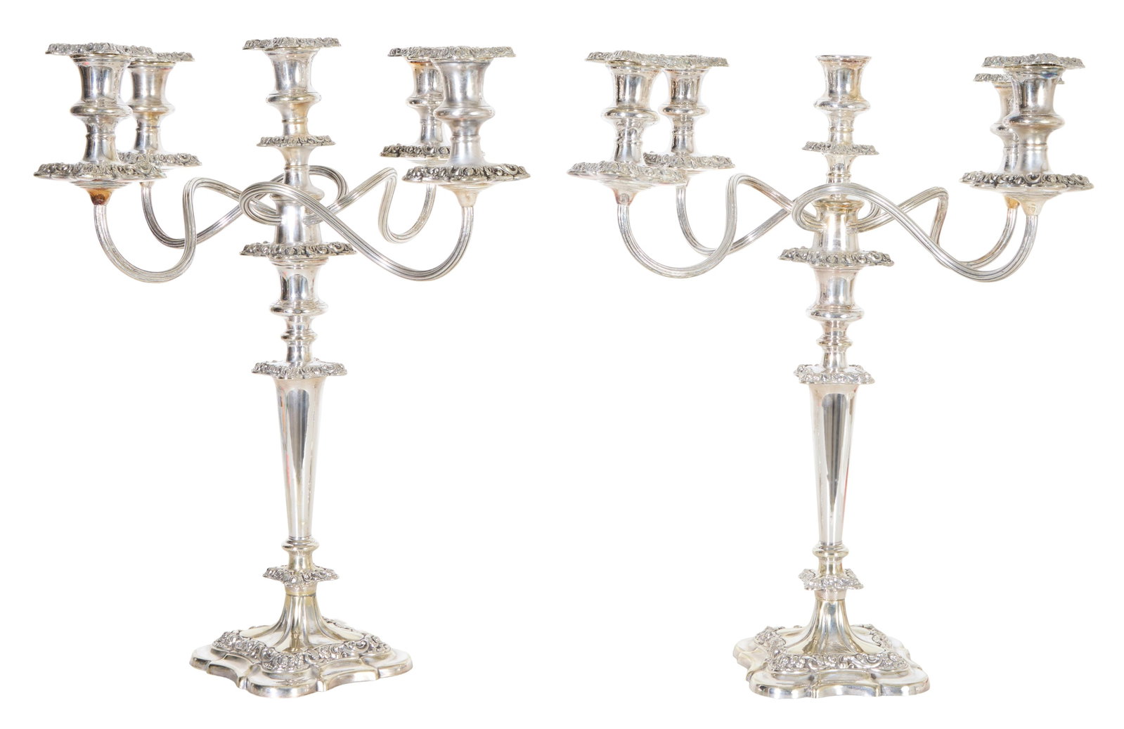 Pair of Ornate Georgian Style Silverplated Five Light Candelabra, 20th c., Each- H.- 18 1/2 in.,: Pair of Ornate Georgian Style Silverplated Five Light Candelabra, 20th c., with a center straight candle cup and four swirled arms, all with relief square bobeches, on a tapered support, to a stepped 