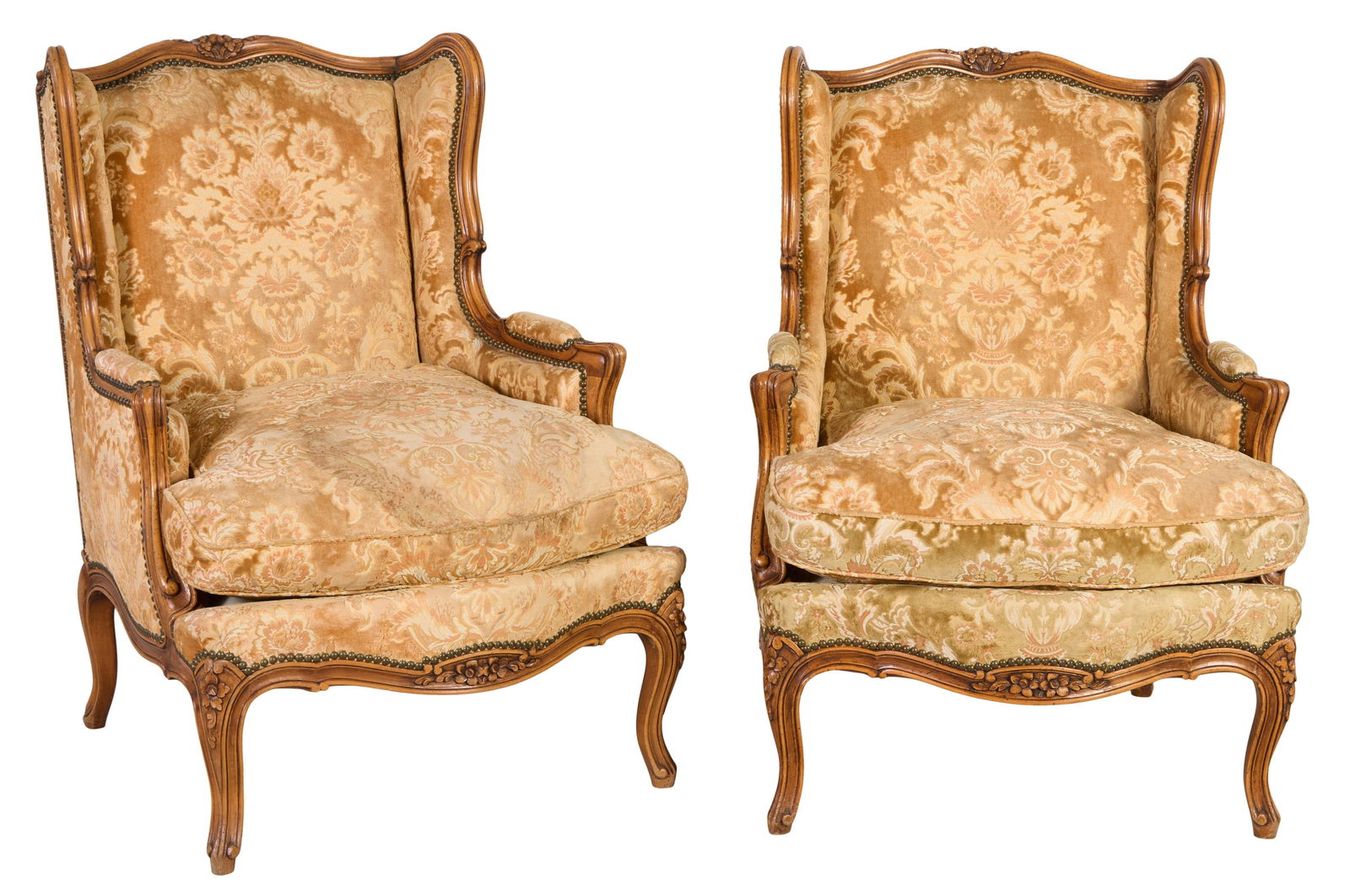 Pair of French Louis XV Style Carved Beech Wing Back Bergeres, early 20th c., Each- H.- 36 in., W.-: Pair of French Louis XV Style Carved Beech Wing Back Bergeres, early 20th c., the shaped floral carved crest into side wings, flowing into scrolled padded arms, above an upholstered removable cushion,
