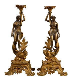 Pair of Art Nouveau Figural Gilt Bronze Candlesticks, late 19th c., H.- 17 3/4 in., W.- 7 3/4 in.,: Pair of Art Nouveau Figural Gilt Bronze Candlesticks, late 19th c., with nubile maidens upholding floriform candle holders, on a pierced base on four splayed legs. H.- 17 3/4 in., W.- 7 3/4 in., D.- 6