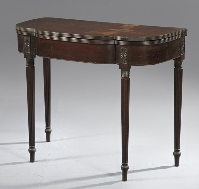 English Carved Mahogany Fold Over Games Table, c. 1940,: English Carved Mahogany Fold Over Games Table, c. 1940, with a shaped top with a reeded edge, on reeded legs, H.- 29 3/8 in., W.- 35 5/8 in., D.- Closed- 17 3/4 in., Open- 35 1/2 in.
