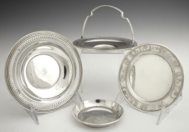 Four Pieces of Sterling, 20th c., consisting of a retic: Four Pieces of Sterling, 20th c., consisting of a reticulated sweetmeats bowl, by SSMC; a coaster by Towle, #501; a salver with a repousse rim by Mauser; and a handled basket with a floral relief rim,
