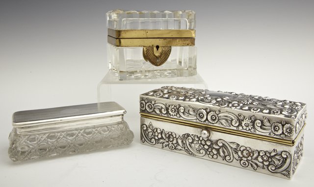 Group of Three Dresser Boxes, consisting of a brass and: Group of Three Dresser Boxes, consisting of a brass and crystal example; one cut crystal with a sterling top, date mark obscured; and one sterling over brass, Birmngham, 1896, with repousse floral and