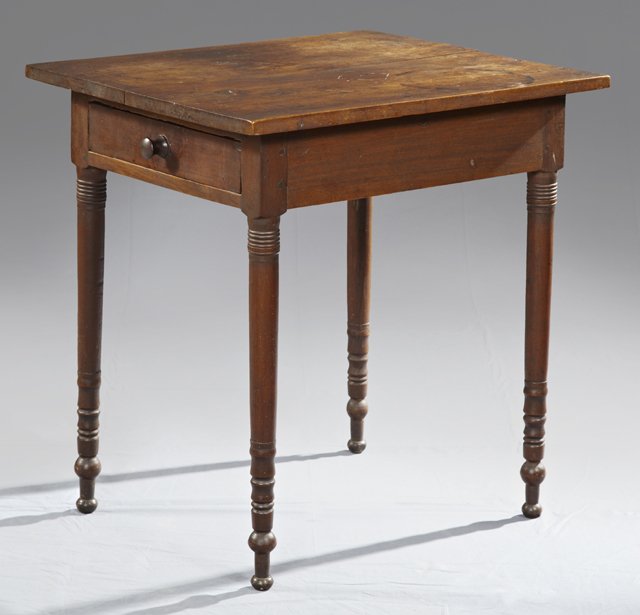 American Carved Walnut Lamp Table, c. 1870, with one en: American Carved Walnut Lamp Table, c. 1870, with one end drawer, the whole on turned tapering legs to ball feet, H.- 29 1/4 in., W.- 28 in.