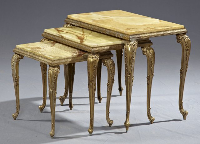 Nest of Three Brass and Onyx Tables, early 20th c., the: Nest of Three Brass and Onyx Tables, early 20th c., the inset highly figured onyx tops within relief frames, on relief cabriole legs to French toes, largest- H.- 17 1/2 in., W.- 21 1/2 in., D.- 14 in.
