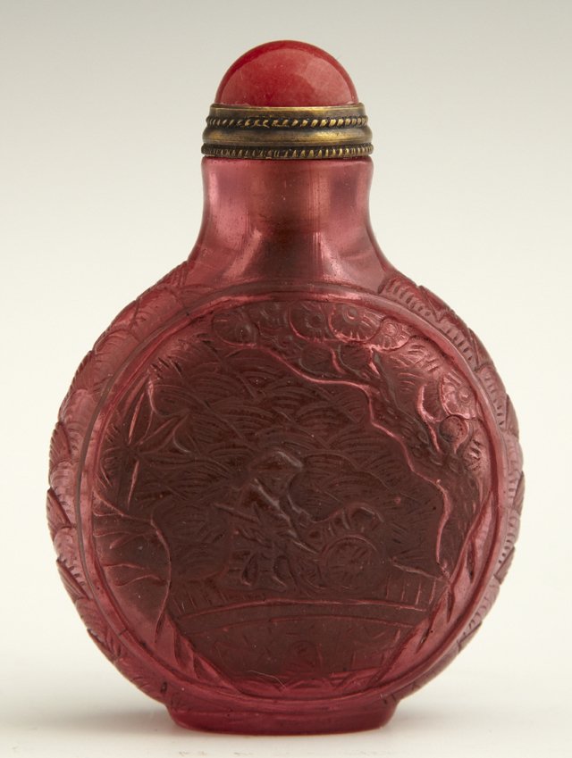 Purple Peking Glass Snuff Bottle, late 19th c., well ca: Purple Peking Glass Snuff Bottle, late 19th c., well carved with two sages on one side, the other with a farmer and a cart, the lid mounted with a carnelian, H.- 2 3/4 in., W.- 1 7/8 in., D.- 1 in., P