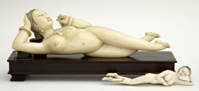 Two Chinese Carved Ivory Medicine Ladies, early 20th c.: Two Chinese Carved Ivory Medicine Ladies, early 20th c., the larger on a carved mahogany stand, the smaller with a snake tattoo, Larger- H.- 2 in., W.- 6 7/8 in., D.- 1 1/4 in.(2 Pcs.)