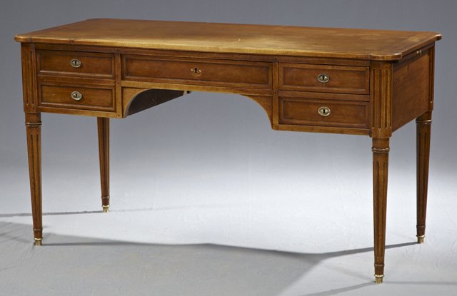 Louis XVI Style Carved Walnut Desk, late 19th c., the s: Louis XVI Style Carved Walnut Desk, late 19th c., the stepped cookie corner top over a central frieze drawer flanked on one side by 2 small drawers, and a deep drawer with a faux two drawer front on t