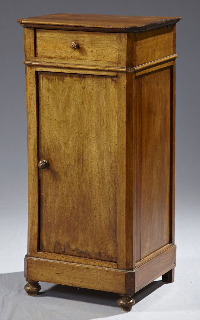 Tall Louis Philippe Carved Walnut Night Stand, c. 1850,: Tall Louis Philippe Carved Walnut Night Stand, c. 1850, the canted corner top over a frieze drawer and a long cupboard door, on a plinth base, on turned bun feet, H.- 37 1/4 in., W.- 18 1/2 in., D.- 1