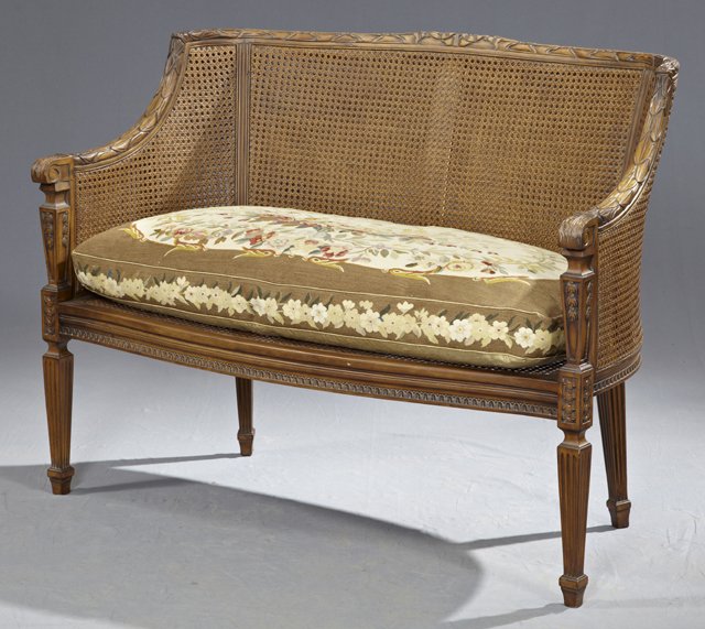 Louis XVI Style Carved Mahogany Caned Settee, late 20th: Louis XVI Style Carved Mahogany Caned Settee, late 20th c., with a double caned back to carved arms and a caned seat, on tapered square reeded legs, with an antique style needlepoint cushion, H.- 35 1