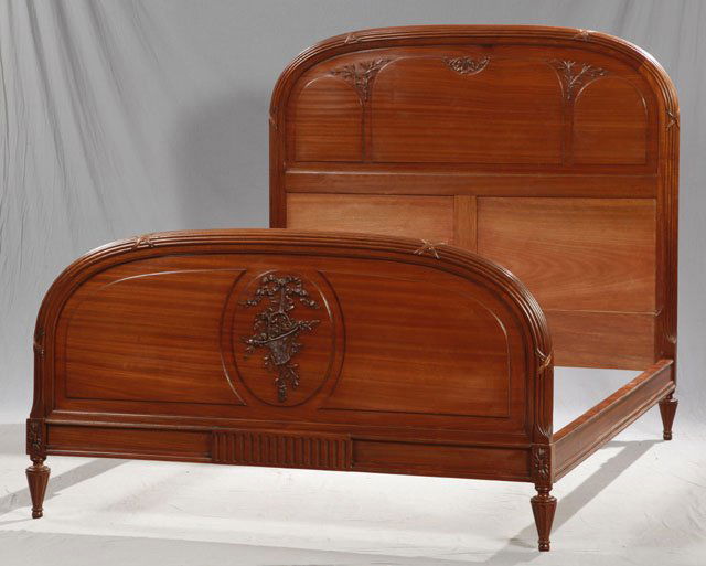 Carved Mahogany Louis XVI Style Double Bed, c. 1920, th: Carved Mahogany Louis XVI Style Double Bed, c. 1920, the arched headboard with a reeded and crossed ribbon border over floral carving, the foot with the same border over a relief carved floral basket