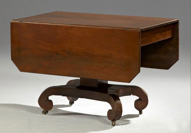 American Classicla Revival Carved Mahogany Drop Leaf Di: American Classicla Revival Carved Mahogany Drop Leaf Dining Table, late 19th c., the canted corner top on a square support, to a quadruped base on large scroll feet, H.- 28 1/2 in., W. Closed- 23 3/4